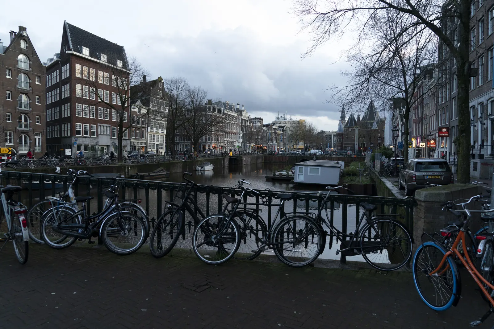 A winter canal in Amsterdam with bicycles along the bridge